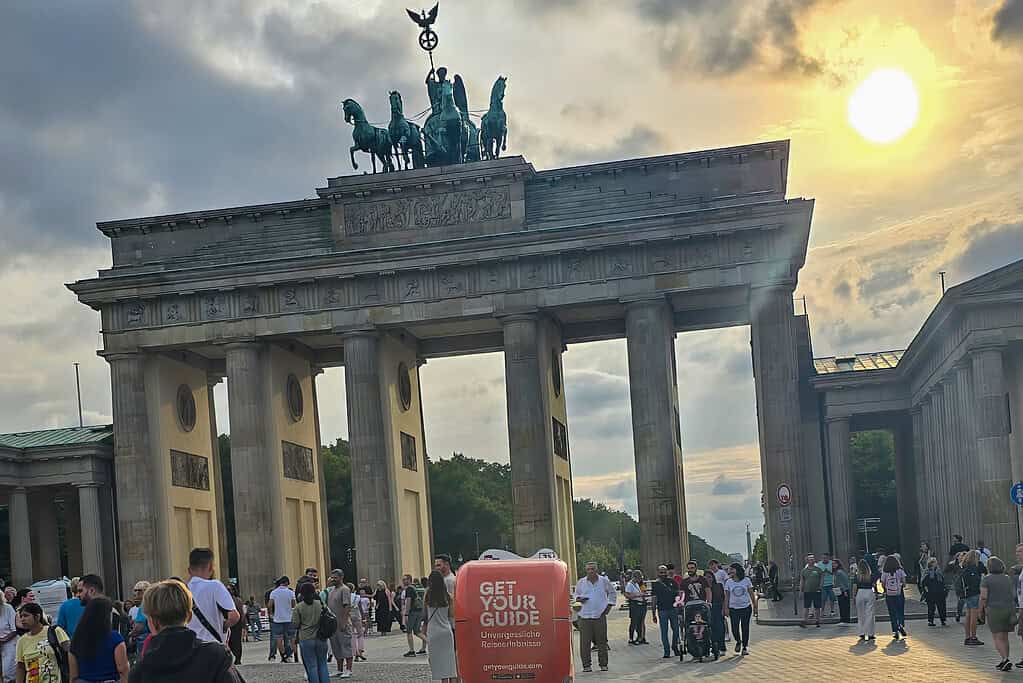 Brandenburger Tor in Berlin bei Sonnenuntergang mit Touristen.